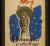 Image of hand holding a torch, with "Democracy...a challenge" printed below.